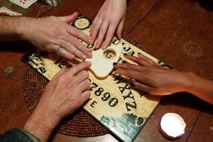 4 hands on a ouiji board.