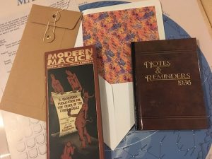 An assortment of items including a journal from 1936 and a pamphlet titled "Modern Magick."