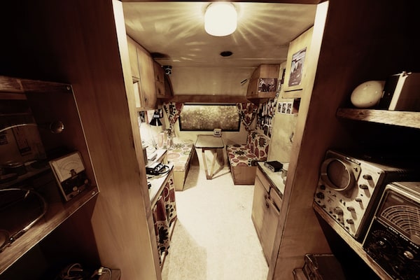 In-game: A view from the entrance of Ernie Hudson's mobile home. His gear is visible on all sides.