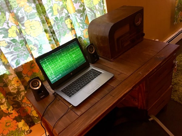 In-game: a laptop on a very old desk.