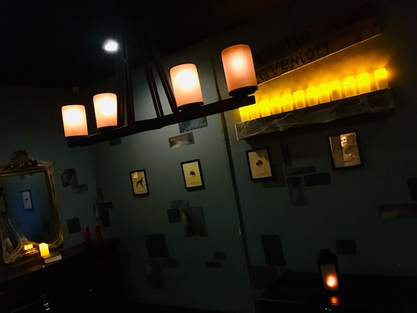 In-game: a dimly lit room lit by over a dozen candles.