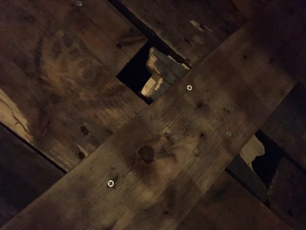 In-game: Closeup of a broken piece of wood in an old coffin.