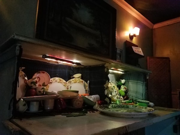 A sideboard filled with haphazardly stacked dishes.