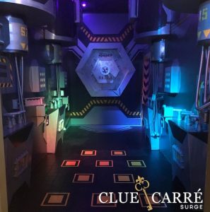 In-game: A large hexogonal door at the end of a corridore filled with tubs and connectors and other technology.