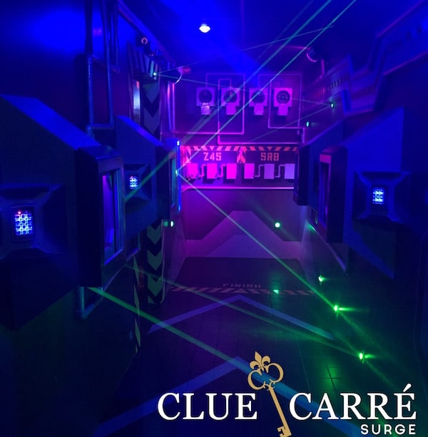 In-game: a maze of green lazers inside of a sleek, blue spaceship.