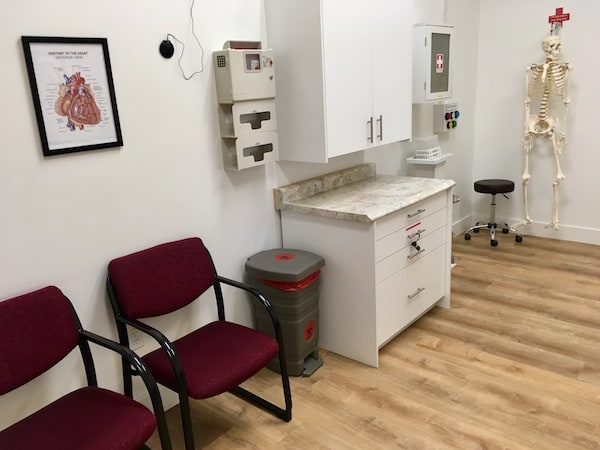 In-game: A wide angle shot of the medical office. It looks like a doctor's office.