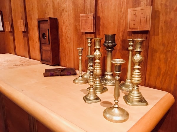 In-game: A collection of candle sticks on a table.