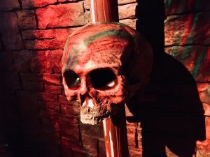 In-game: A human skull on a spike in a tomb.