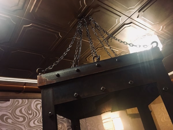 In-game: A water torture chamber hanging from the ceiling.