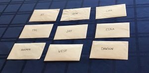9 character envelopes, each with a different name on it.