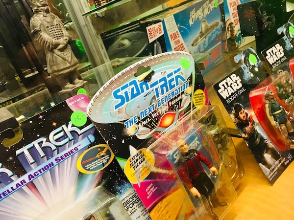 In-game: Closeup of Star Trek and Star Wars action figures.
