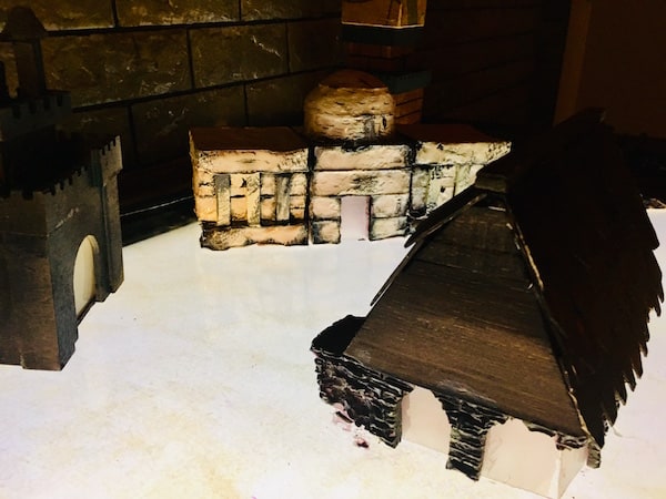 In-game: A glowing table with building models resting atop it.