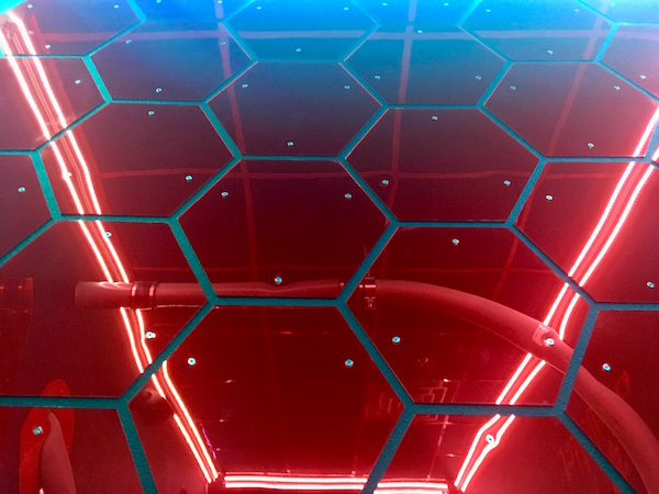 In-game: A reflective wall of red hexagons.