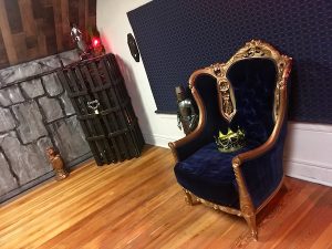 In-game: a large throne with a crown sitting on the seat.