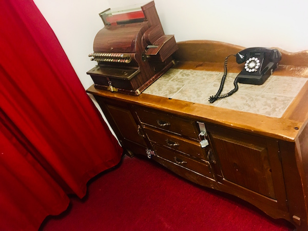 In-game: an antique cash register on a tabletop.