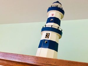 In-game: closeup of a lighthouse model with a #3 on it.