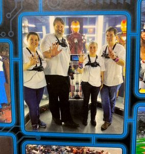 The team in a room surrounded by Ironman suits.