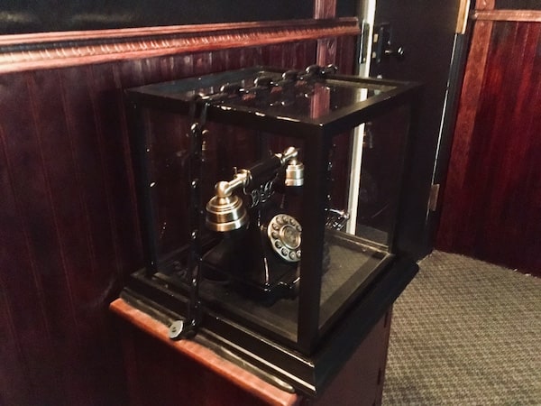 In-game: A faux rotary phone encased in glass and chained shut.