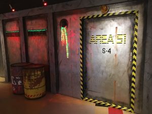 The entryway to Area 51 S-4. The walls are metal, and there is radio active material off to the side.