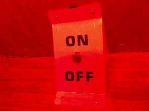 In-game: closeup of a red on/ off switch.
