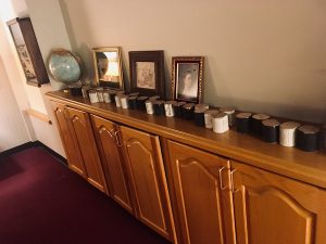 In-game: A long wooden cabinet covered in black and white blocks of wood.