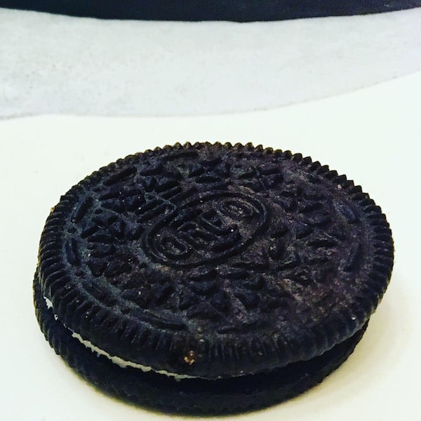 Closeup of a whole oreo on a plate.