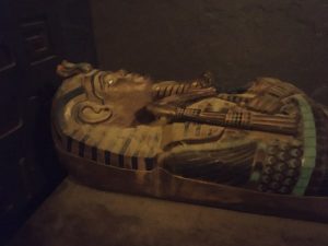 In-game: A sarcophagus covered in sand.