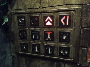 In-game: A set of stone symbols arranged in a 3 by 4 grid, one symbol glows red.