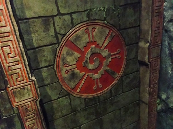 In-game: Closeup of a doorway with a large symbol carved into the stone.