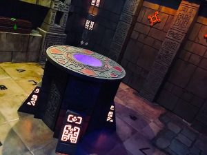 In-game: a large stone alter in the middle of a temple. A blue light glows from the center of the alter.