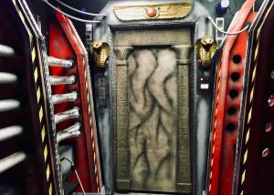 In-game: Wide angle view of the tomb's doorway surrounded by contianment tech.