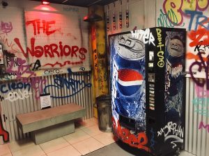In-game: graphittied subway walls with a Pepsi vending machine.