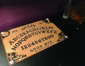 In-game: a Ouija board on a desk.
