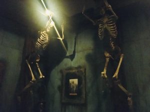 In-game: Two skeletons mounted to beams on the wall.