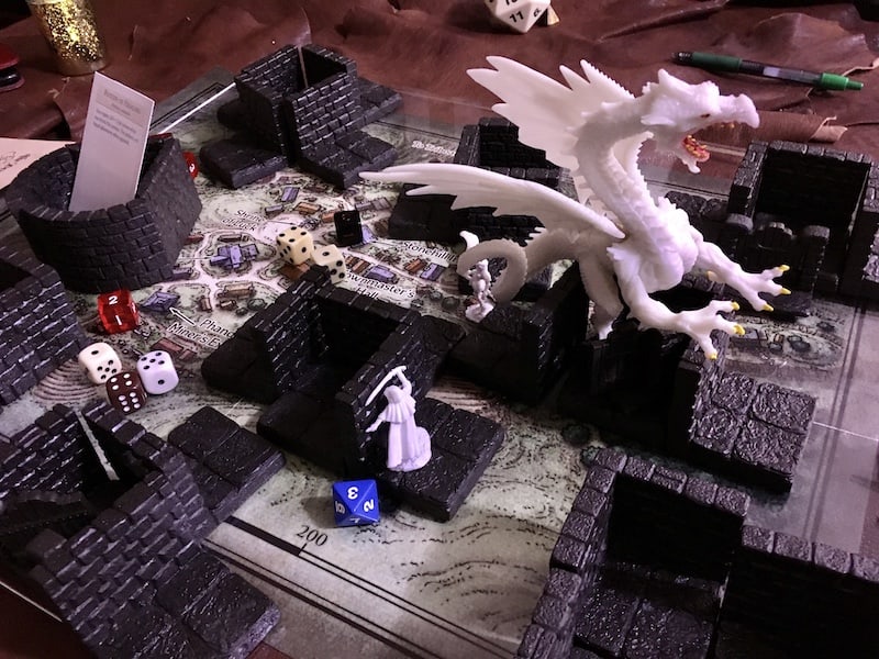The game map, characters, dice, buildings, and a white dragon strewn about the map.
