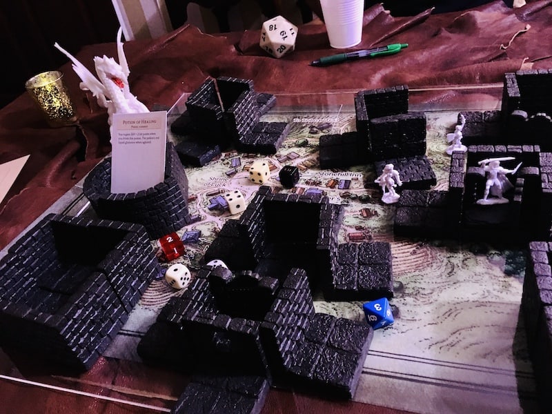 The game map with our characters in buildings, and a dragon approaching.