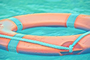 An orange life ring floating in a pool.