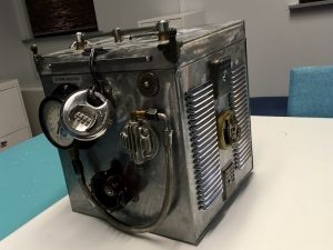 In-game: an unusual metal crate with all manner of machinery on it.