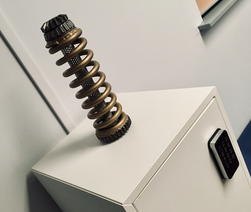 In-game: An unusual coil-like device sitting atop a locked cabinet.
