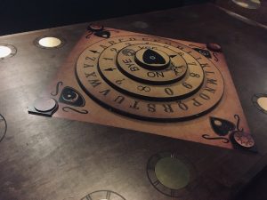 In-game: A stacked, twistable Ouiji board.