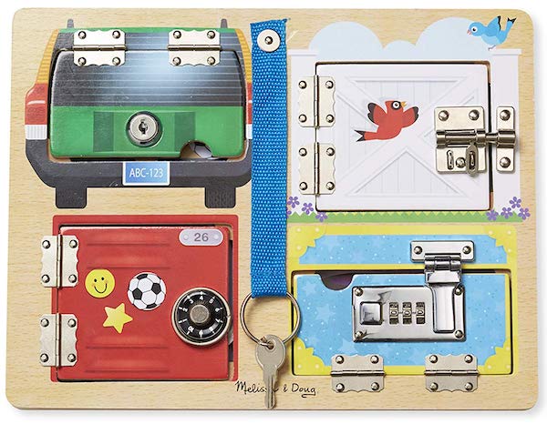 A child's latch board with a keyed lock, a gate latch, a combination lock, and a briefcase lock.