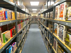 A very long aisle filled with jigsaw puzzle boxes.