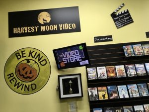 In-game: The Harvest Moon Video logo beside a large sign that reads, "Be kind rewind."