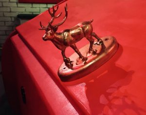 In-game: closeup of a golden raindeer hood ornament.