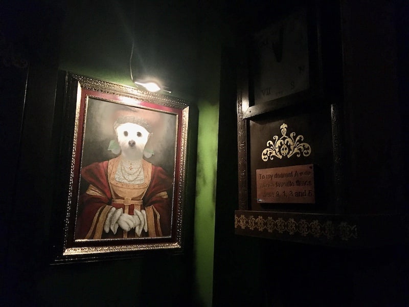 In-game: Portait of a dog dressed as a human beside an old grandfather clock.