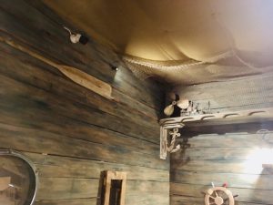 In-game: The wood and canvas walls and ceiling of the boat's interior.