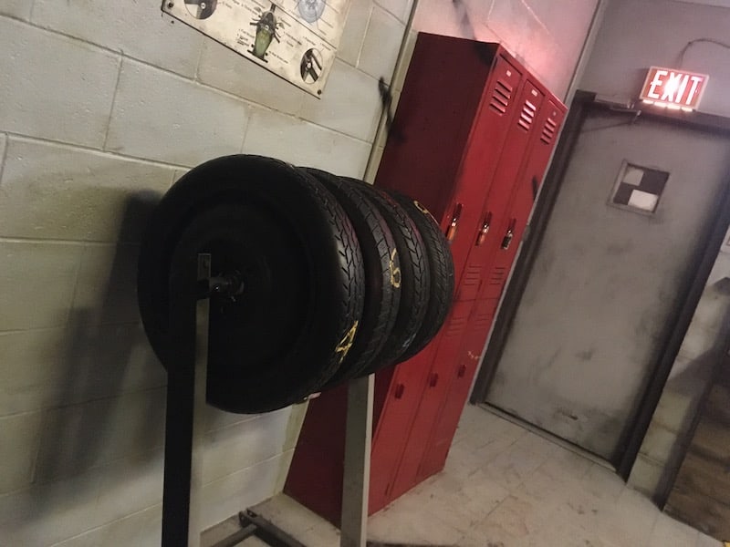 In-game: a rack of tires sitting beside a set of red lockers.