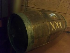 In-game: closeup of a barrel labeled "xxx"