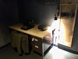 In-game: A desk with a locked box and an old typewriter atop it.