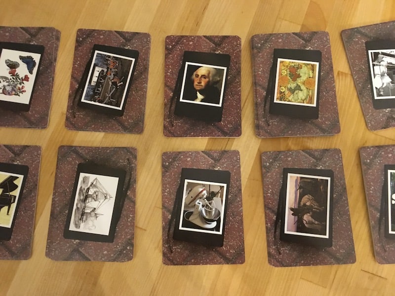 10 stacks of cards with photographs and art on the back.